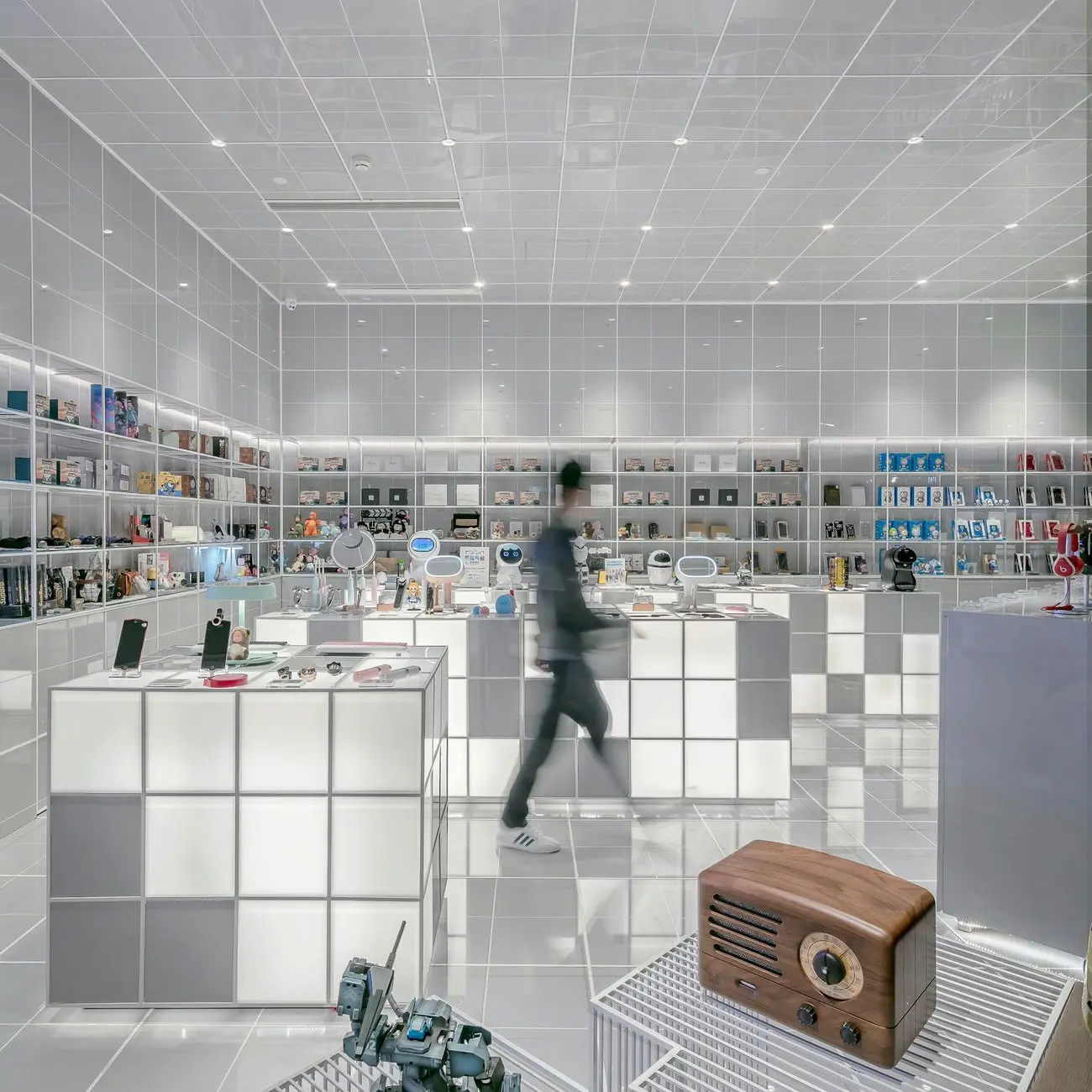 man walking beside white cube decoration